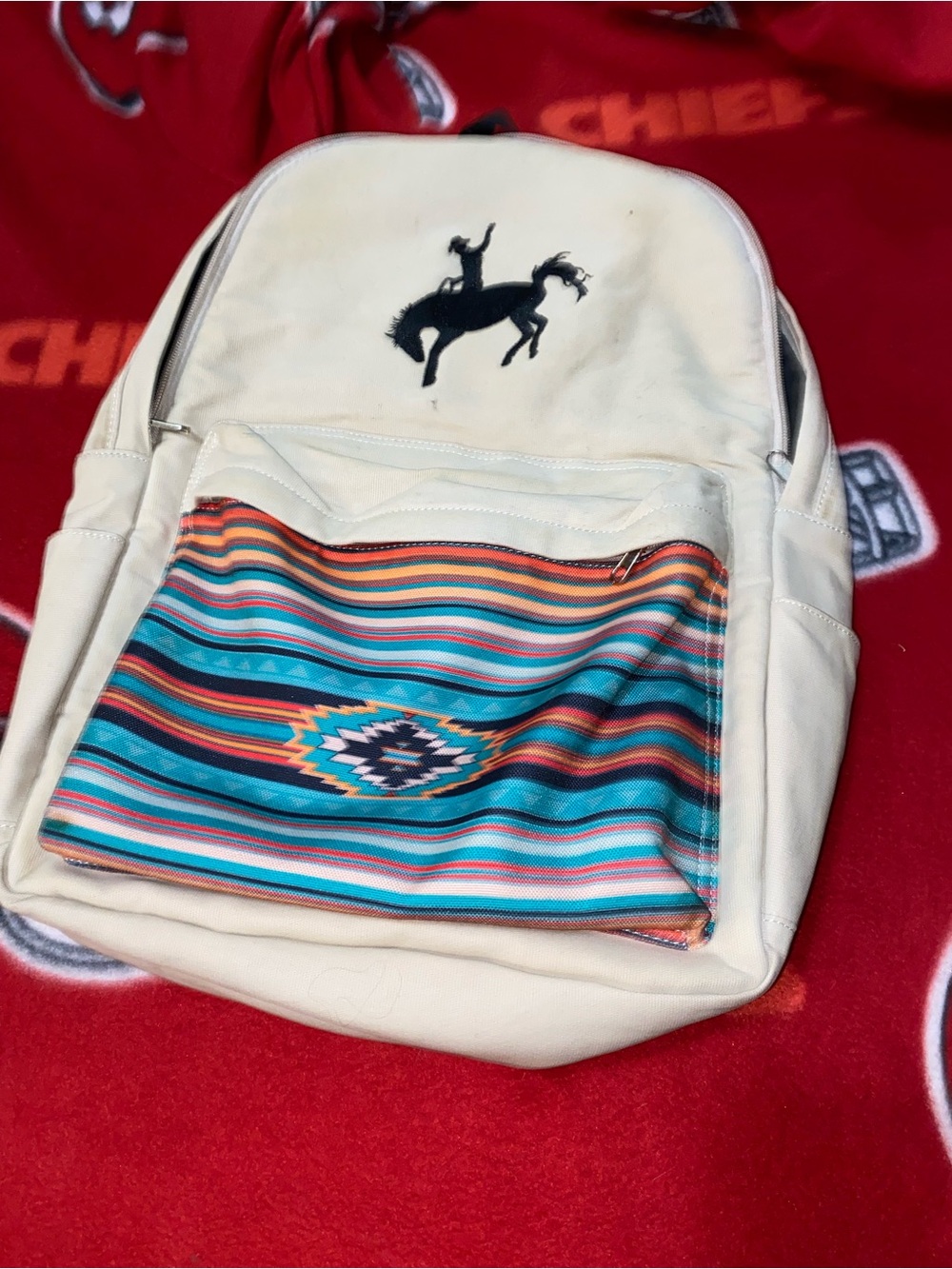 Cream colored Rowdy Crowd backpack NWT has Turquoise Patterned Front Pocket